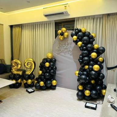 A half arch black and gold balloon garland